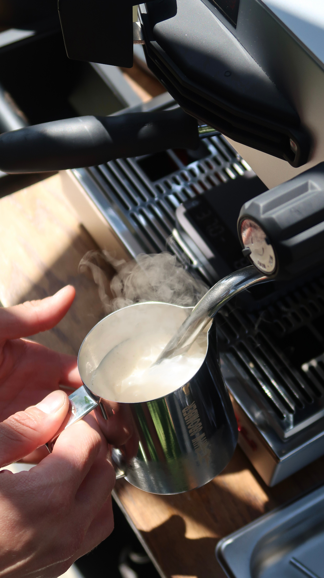 Barista steaming milk for wedding reception lattes