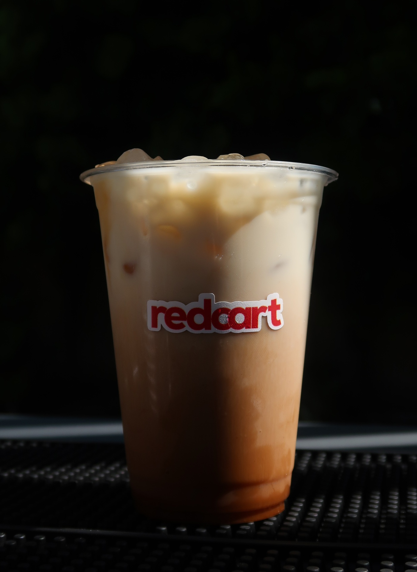 Redcart iced latte in a branded cup